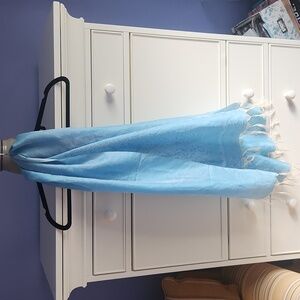 NWOT lightweight, light blue silk scarf with white fringe.